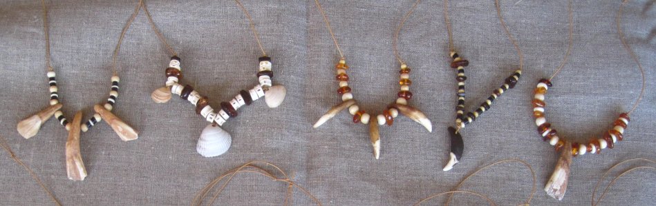 stone age necklaces with teeth, bone, amber and shell beads