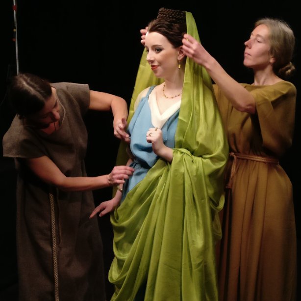 ancient roman lady getting dressed  by two slaves
