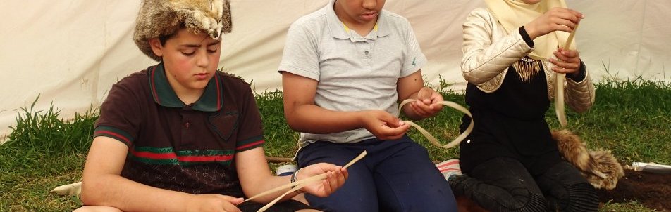 children making string from plant fibers